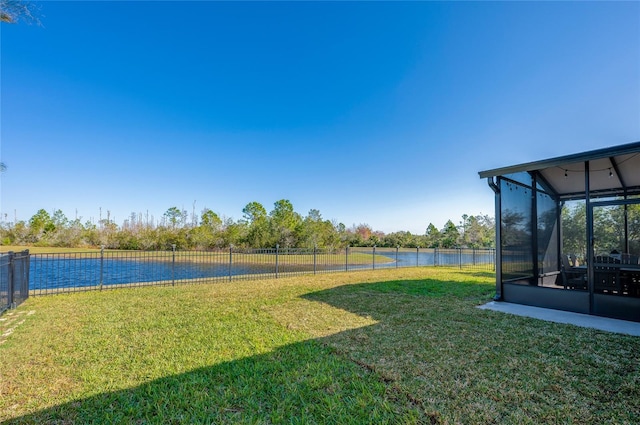 view of yard with a water view and a sunroom