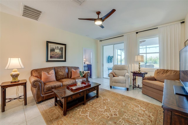 tiled living room with ceiling fan