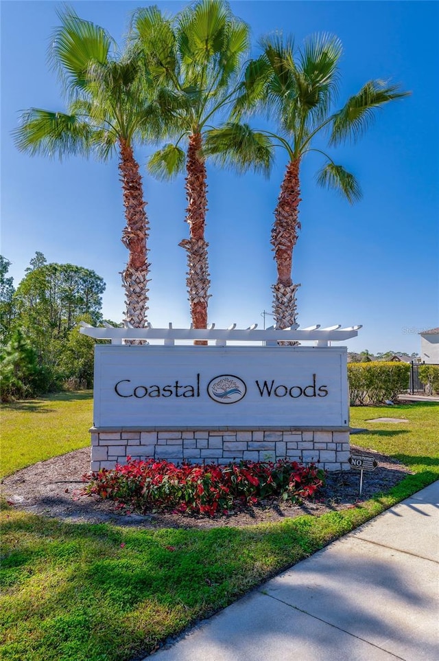 community / neighborhood sign featuring a lawn