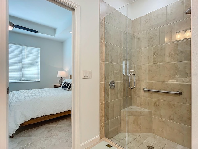 bathroom with connected bathroom, a shower stall, and baseboards