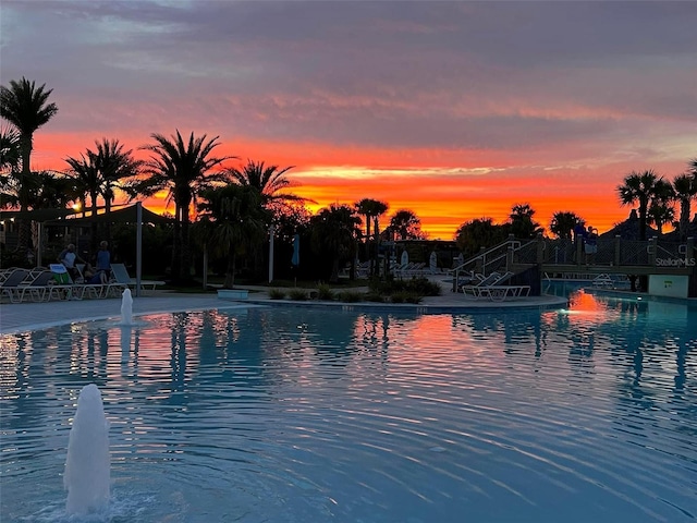 view of pool at dusk