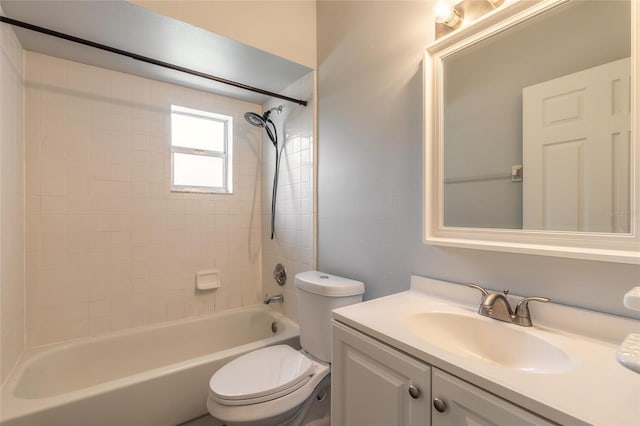 full bathroom with tiled shower / bath combo, vanity, and toilet