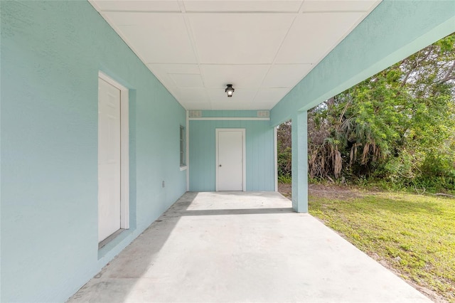 property entrance featuring a yard and a patio