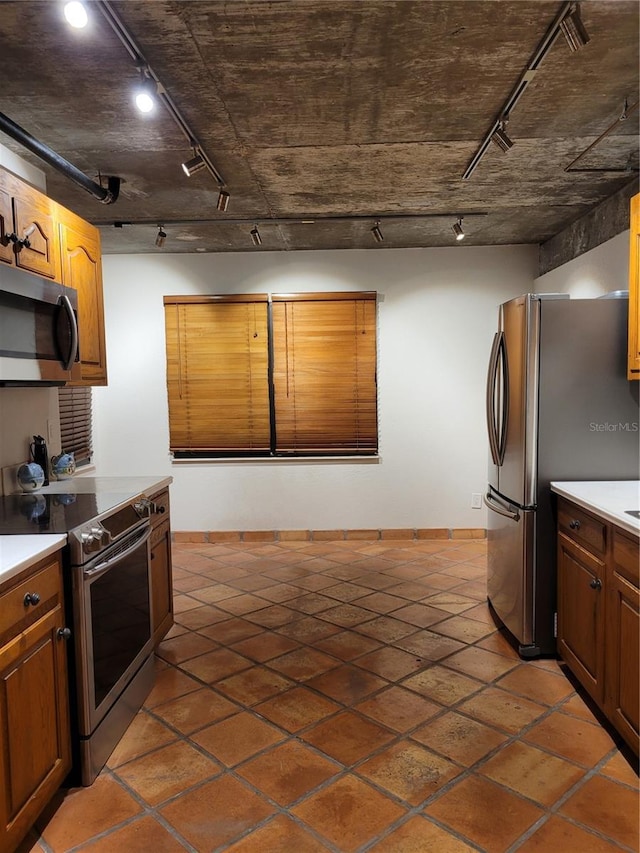 kitchen with track lighting and stainless steel appliances