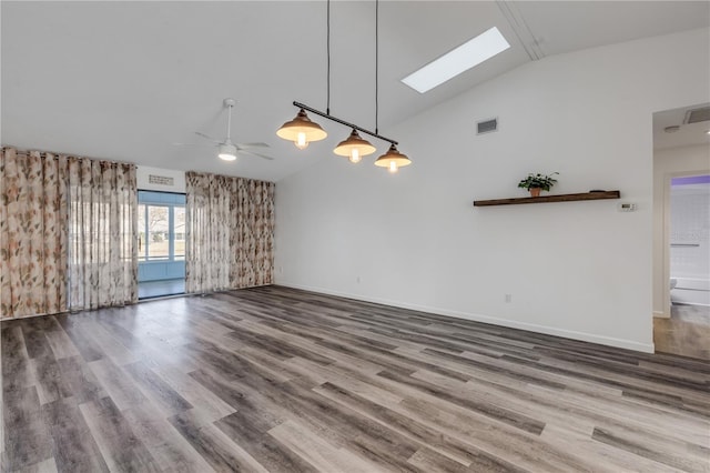 unfurnished living room featuring hardwood / wood-style flooring, ceiling fan, a skylight, and high vaulted ceiling