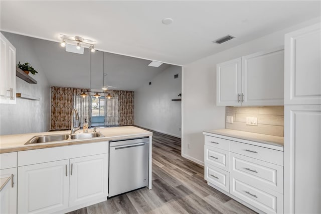 kitchen featuring sink, white cabinets, backsplash, hanging light fixtures, and stainless steel dishwasher