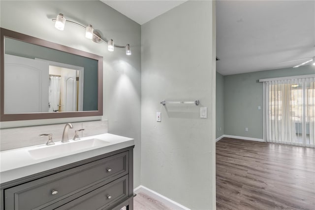 bathroom featuring vanity, wood-type flooring, and ceiling fan