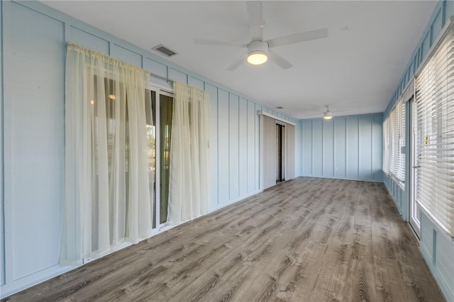 empty room featuring ceiling fan and light wood-type flooring