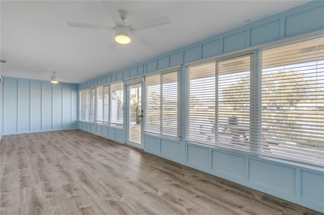 empty room with ceiling fan and light wood-type flooring