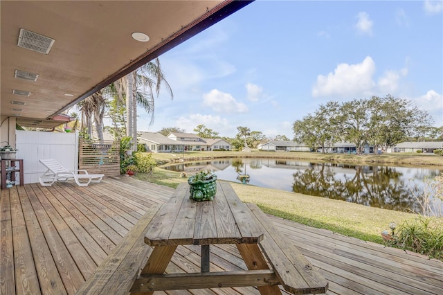 wooden terrace featuring a water view