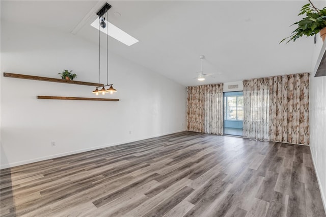 unfurnished living room with hardwood / wood-style flooring, a skylight, high vaulted ceiling, and ceiling fan