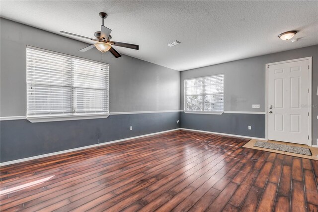 2707 Atlantis Dr, New Smyrna Beach, FL 32168 - spare room featuring ceiling fan, lofted ceiling, a textured ceiling, and dark hardwood / wood-style flooring