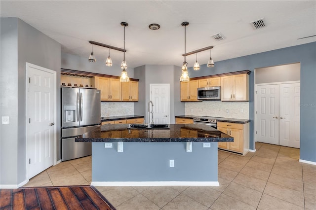 2707 Atlantis Dr, New Smyrna Beach, FL 32168 - kitchen featuring backsplash, a center island with sink, sink, and appliances with stainless steel finishes