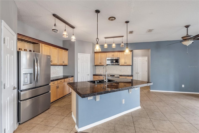 2707 Atlantis Dr, New Smyrna Beach, FL 32168 - kitchen featuring appliances with stainless steel finishes, a kitchen island with sink, a kitchen bar, and decorative backsplash