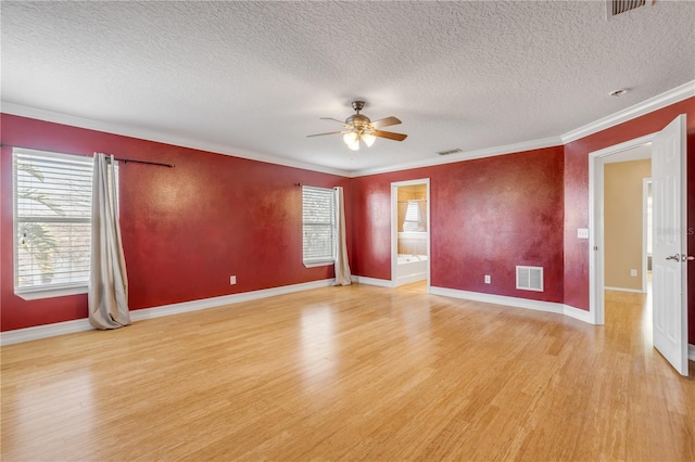 2707 Atlantis Dr, New Smyrna Beach, FL 32168 - spare room with a textured ceiling, ornamental molding, ceiling fan, and light wood-type flooring