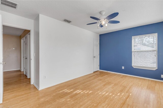 2707 Atlantis Dr, New Smyrna Beach, FL 32168 - spare room with ceiling fan, light hardwood / wood-style flooring, and a textured ceiling