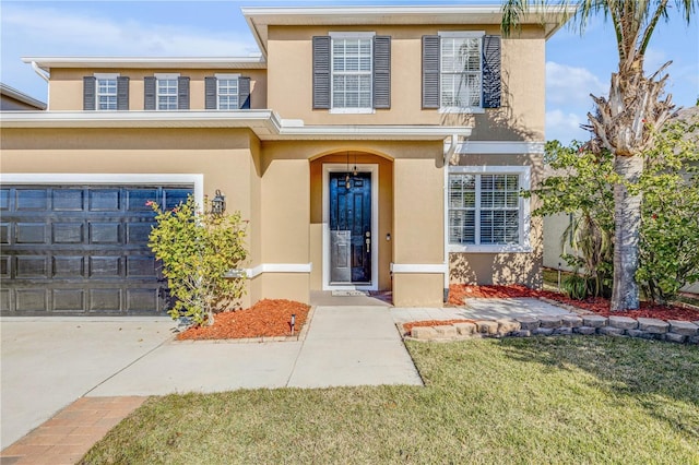 2707 Atlantis Dr, New Smyrna Beach, FL 32168 - view of exterior entry featuring a garage and a lawn
