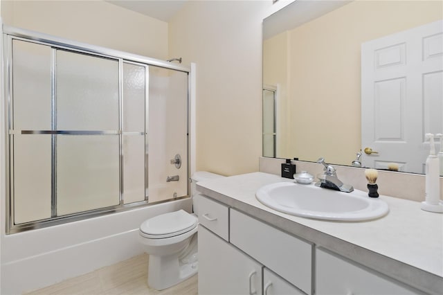 full bathroom featuring vanity, toilet, and combined bath / shower with glass door