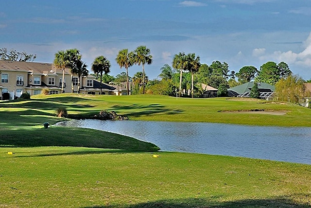 view of property's community featuring a water view and a yard