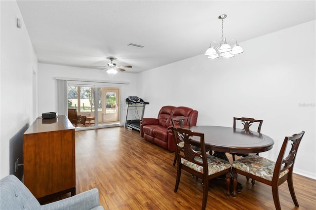 dining room with hardwood / wood-style flooring and ceiling fan with notable chandelier