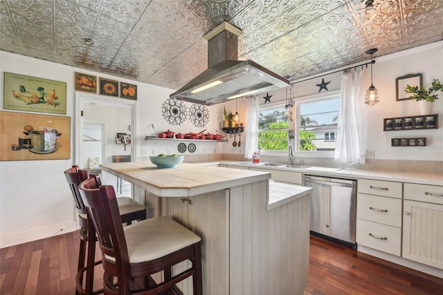 kitchen featuring dishwasher, island exhaust hood, sink, a kitchen breakfast bar, and dark hardwood / wood-style floors