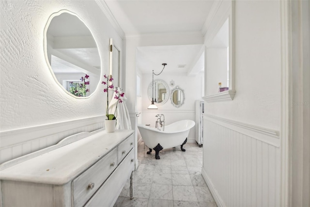 bathroom with crown molding, radiator heating unit, a bathing tub, and vanity