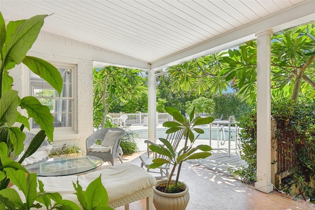 sunroom / solarium with lofted ceiling