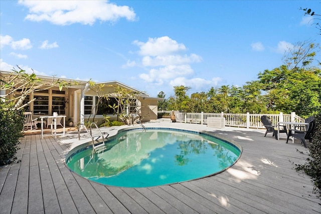 view of swimming pool with a deck