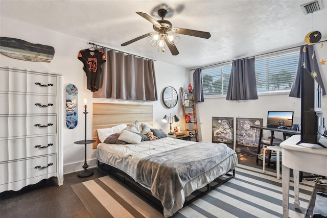 bedroom with a textured ceiling and ceiling fan