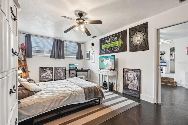 bedroom with ceiling fan and a textured ceiling