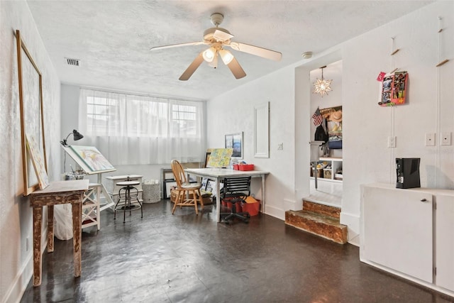 miscellaneous room featuring ceiling fan and a textured ceiling