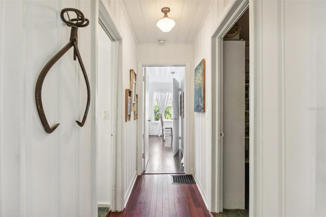 corridor with dark hardwood / wood-style floors and ornamental molding