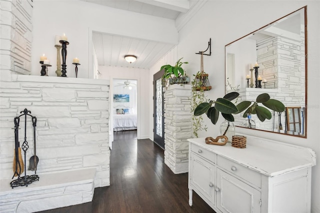 hallway with dark hardwood / wood-style floors and beamed ceiling