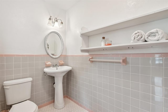 bathroom featuring tile walls, toilet, and tile patterned flooring