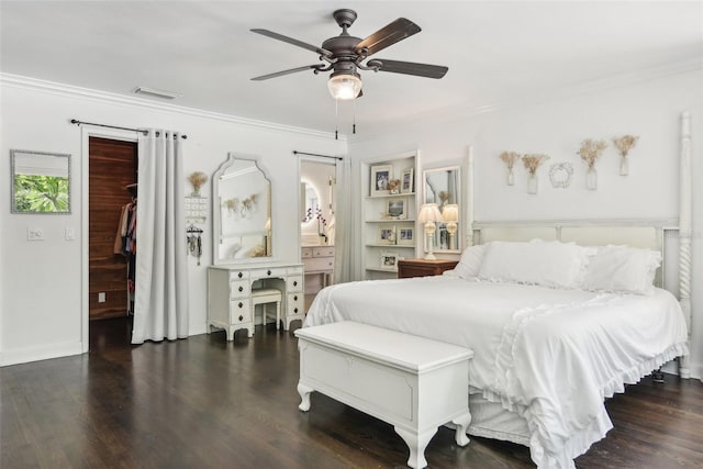 bedroom with ceiling fan, a closet, dark hardwood / wood-style flooring, a walk in closet, and crown molding