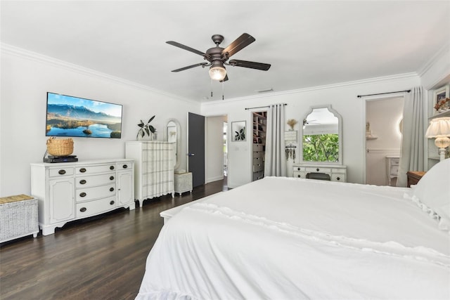 bedroom with ensuite bathroom, ceiling fan, dark wood-type flooring, and crown molding