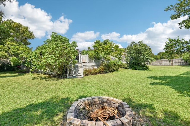 view of yard with a fire pit