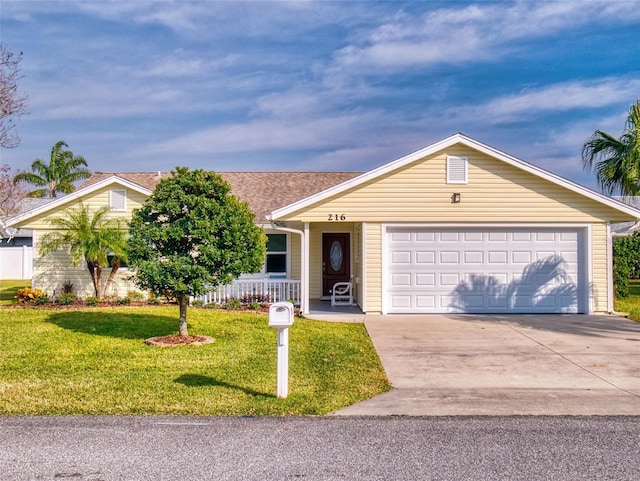 ranch-style home with a garage, a front yard, and covered porch