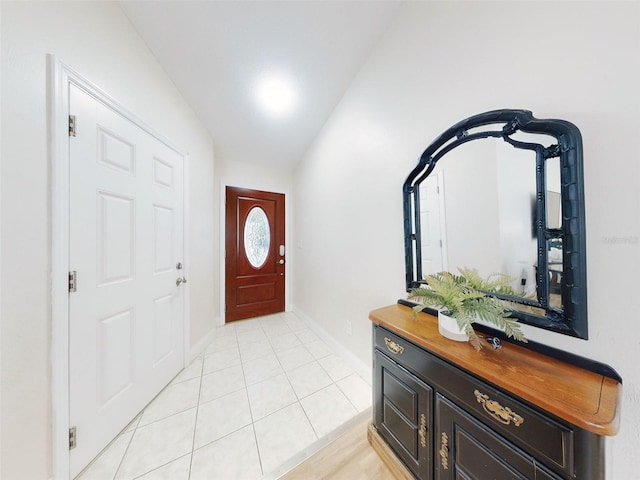 entrance foyer featuring vaulted ceiling and light tile patterned flooring