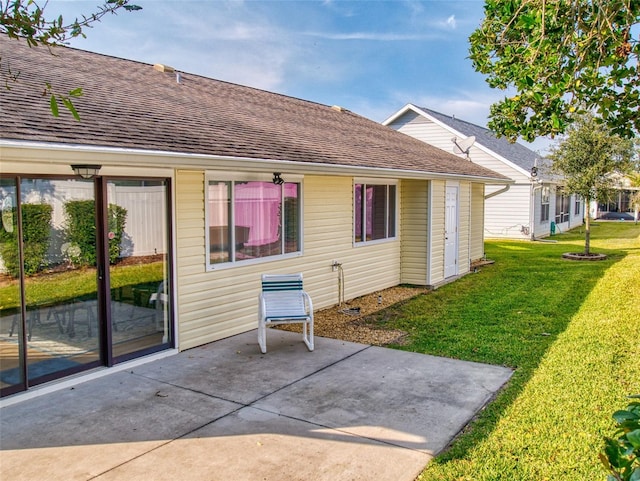 rear view of house featuring a patio and a yard