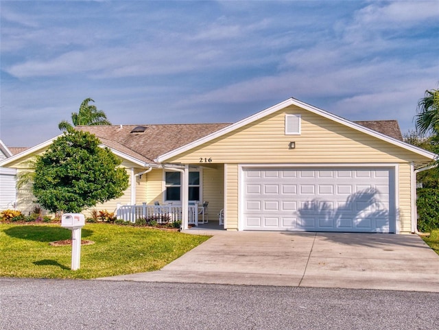 ranch-style house with a garage, covered porch, and a front lawn