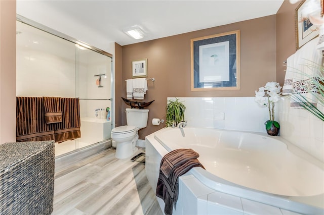 bathroom featuring hardwood / wood-style floors, toilet, and separate shower and tub