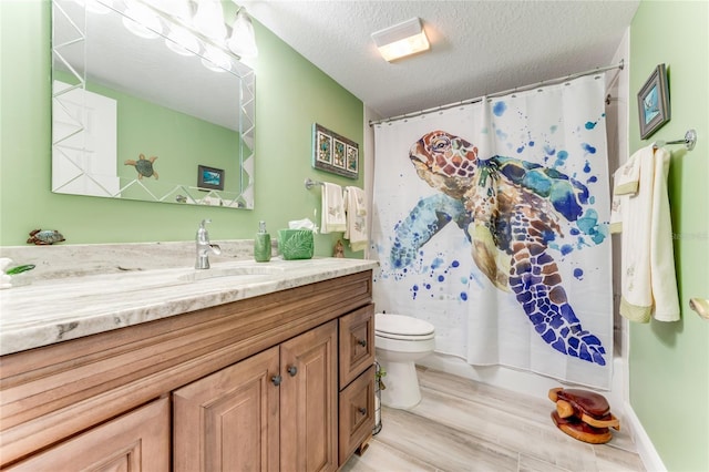 bathroom featuring a shower with shower curtain, vanity, wood-type flooring, a textured ceiling, and toilet