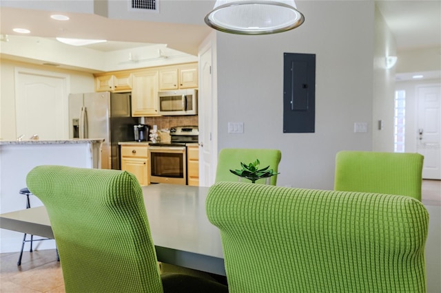 dining space with electric panel and light tile patterned floors