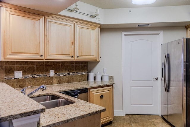 kitchen featuring appliances with stainless steel finishes, light brown cabinetry, light stone countertops, and sink