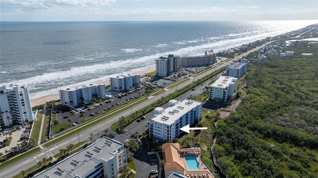 drone / aerial view with a beach view and a water view