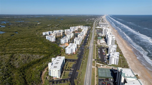 bird's eye view featuring a water view and a beach view