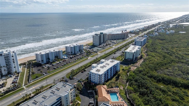 birds eye view of property featuring a water view and a beach view