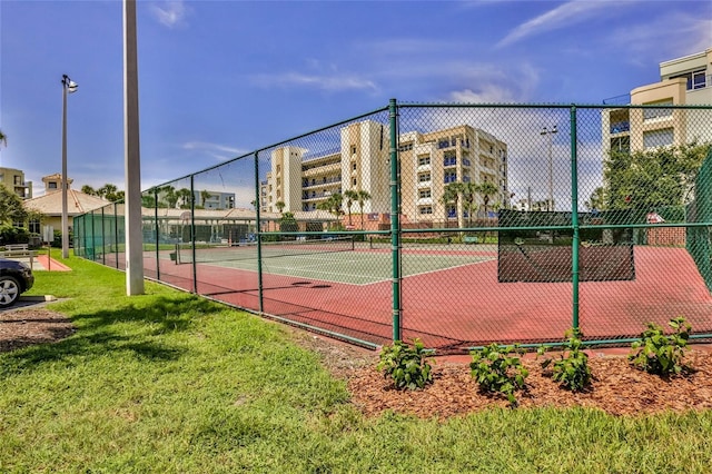 view of sport court featuring a lawn