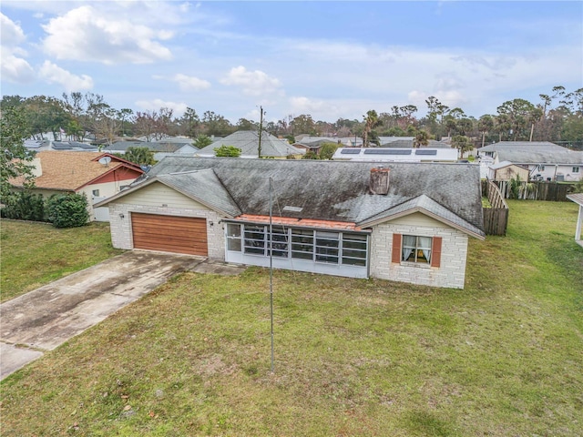 view of front of home with a garage and a front lawn